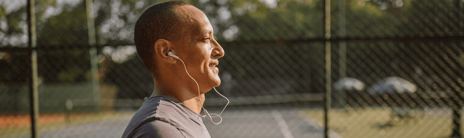 Man jogging outside with corded headphones