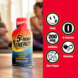 A bottle of 5-hour Energy Regular Strength dietary supplement is shown on floor with a blurred person in the background, alongside a red graphic panel with feature icons for Tasty, 0 Calories, 200 mg Caffeine, Vitamins, and Zero Sugar.
