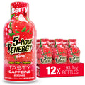 A bottle of 5-hour Energy Berry Tasty Caffeine stands next to a red cardboard tray holding six more bottles. The packaging is predominantly red with illustrations of berries and white text, on a clean white background.