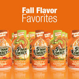 Six bottles of 5-hour Energy Tasty Caffeine in Caramel Apple flavor are lined up against a solid orange background with the text 'Fall Flavor Favorites' above them.