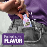 A close-up of a person's hand inserting a miniature bottle of 5-hour energy shot into a gray denim pocket. White and purple text overlays highlight the pocket-sized scale 3.5 inches