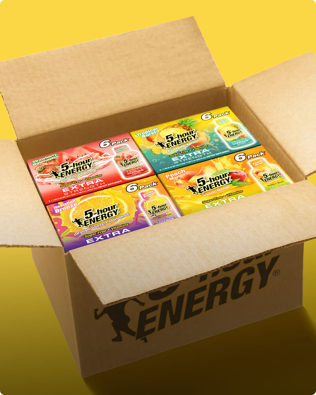 An open brown cardboard box filled with four packs of 5-hour Energy Extra gummy candy in different fruit flavors, set against a solid yellow background.