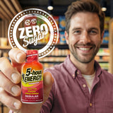 Man holding a 5-hour ENERGY Zero Sugar Pomegranate bottle in a store setting