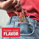 A hand holding a miniature 5-hour Energy drink bottle tucked into a blue denim pocket, with a red graphic overlay reading 'Pocket-sized FLAVOR' and a measurement marker showing 3.5 inches.