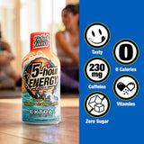 A bottle of Tidal Twist 5-hour Energy Extra Strength drink mix stands on a wooden table with a blurred indoor background. The right side features a blue panel with circular icons highlighting product benefits: tasty, 230 mg caffeine, 0 calories, vitamins, and zero sugar.