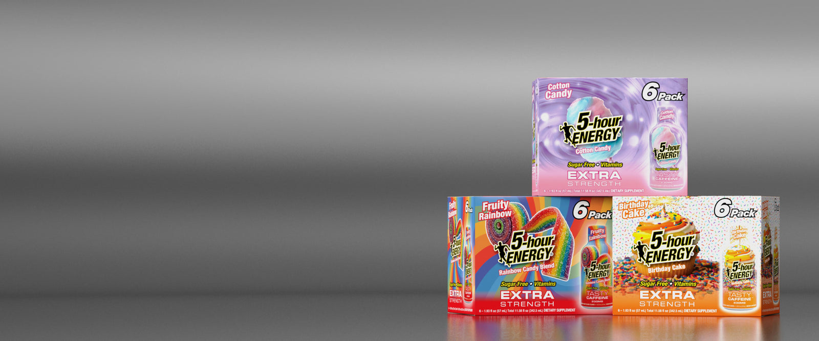 Three stacked packs of 5-hour Energy Extra drink mix in different flavor variants, including cola, coffee, and lemonade, set against a dark gray gradient background.