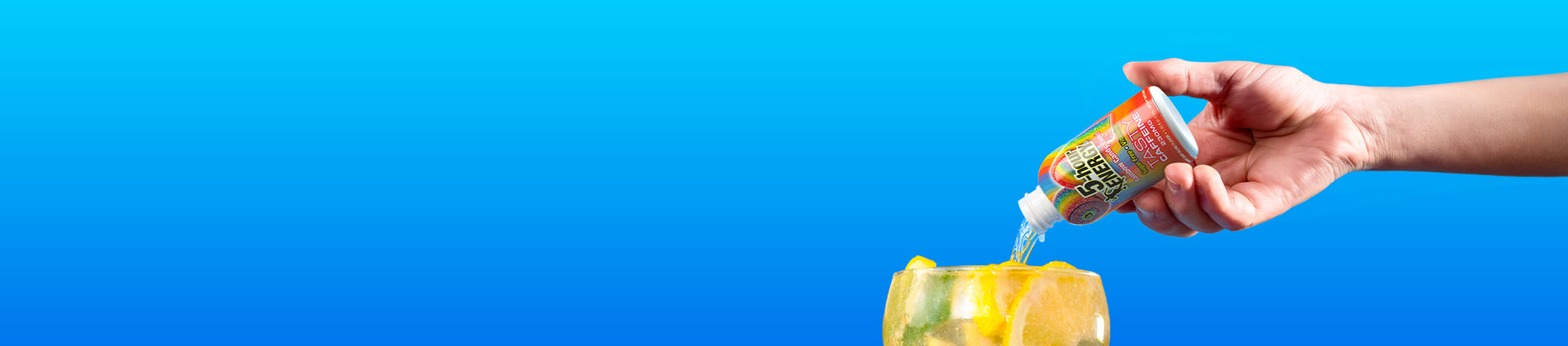A hand holding a small bottle and pouring a clear liquid onto yellow wax or soap against a bright blue gradient background.
